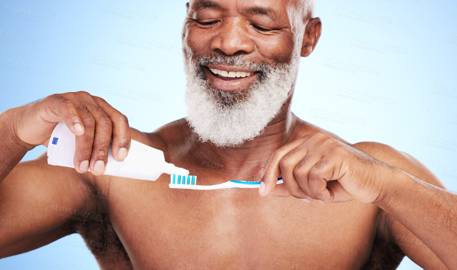 Buy stock photo Black man, toothbrush and toothpaste in studio for brushing teeth, dental care and fresh breath. Mature person, happy and oral on blue background with mouth hygiene for wellness, white or bacteria