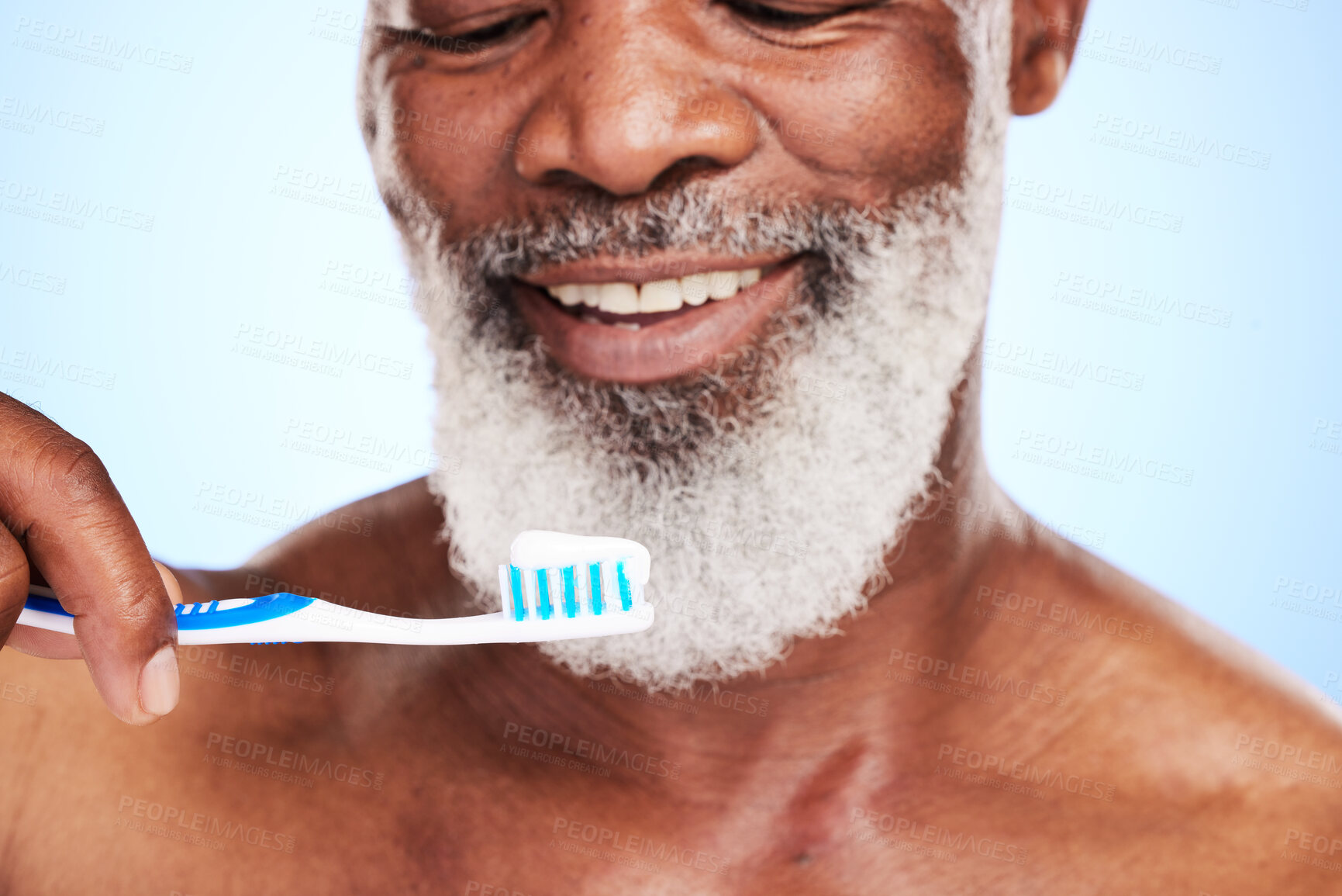 Buy stock photo Mature man, toothbrush and toothpaste in studio for brushing teeth, dental care and fresh breath. Black person, happy and oral on blue background with mouth hygiene for wellness, smile or bacteria