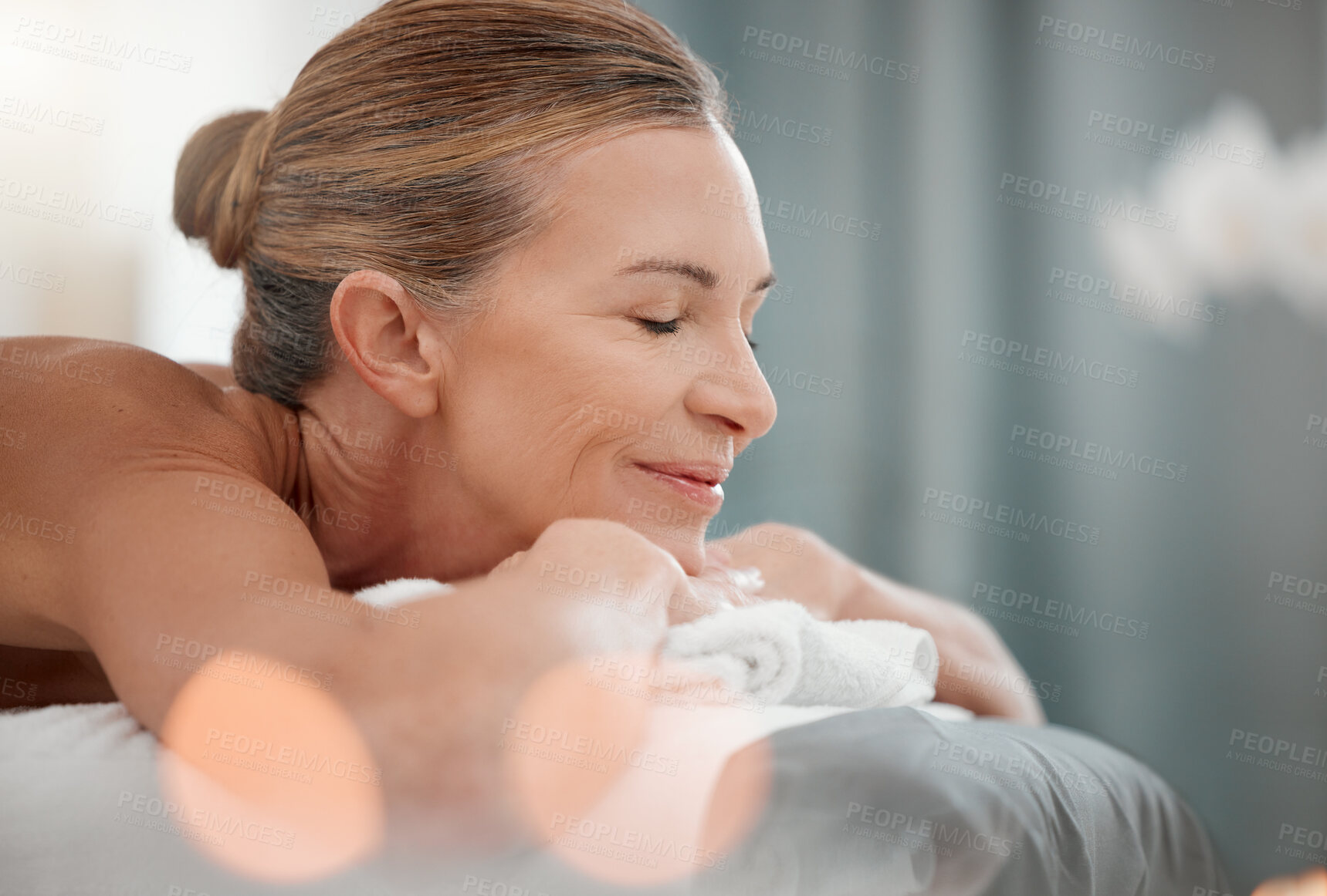 Buy stock photo Spa treatment, peace or mature woman on bed for massage, physical therapy or luxury. Smile, eyes closed or female person in health resort for destress, rest or wellness in hotel for pamper or me time