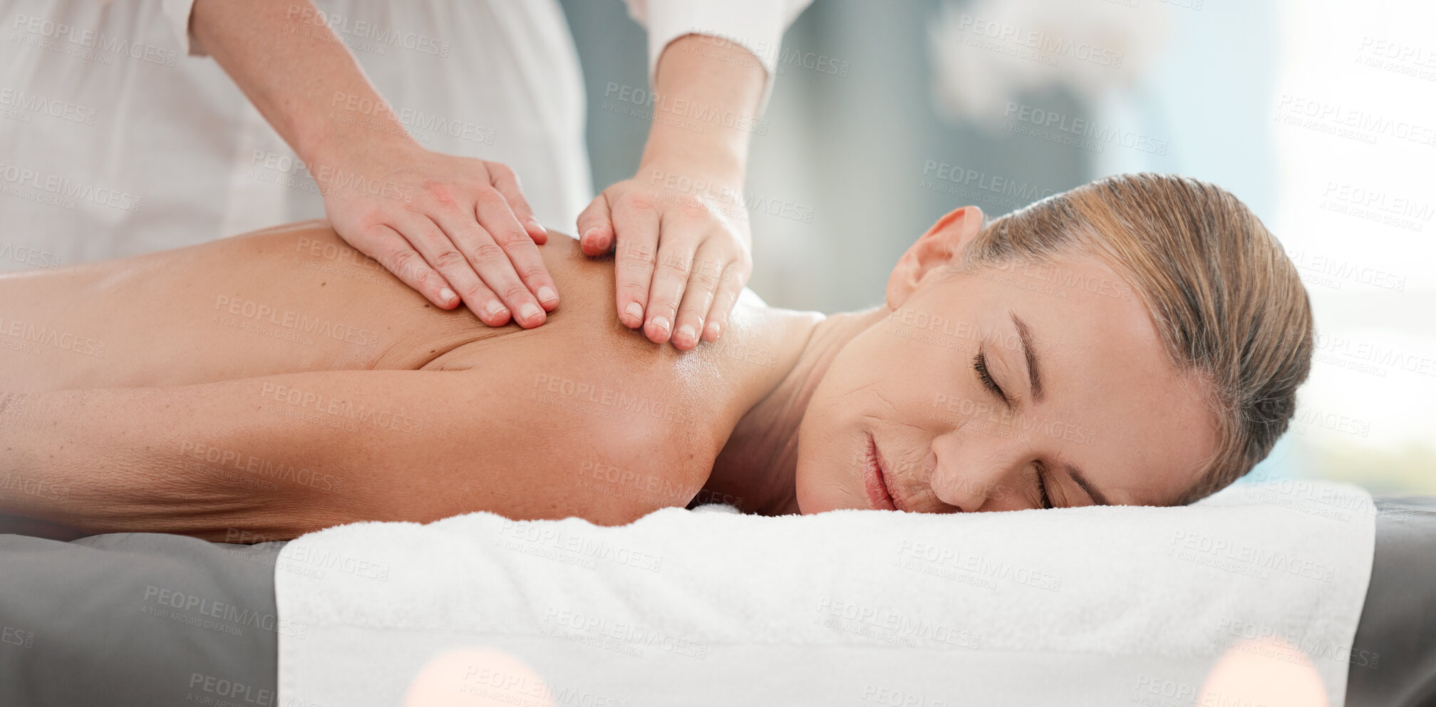 Buy stock photo Shot of a mature woman receiving a back massage at a spa
