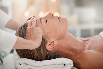 Buy stock photo Shot of a woman receiving a facial massage while at a spa