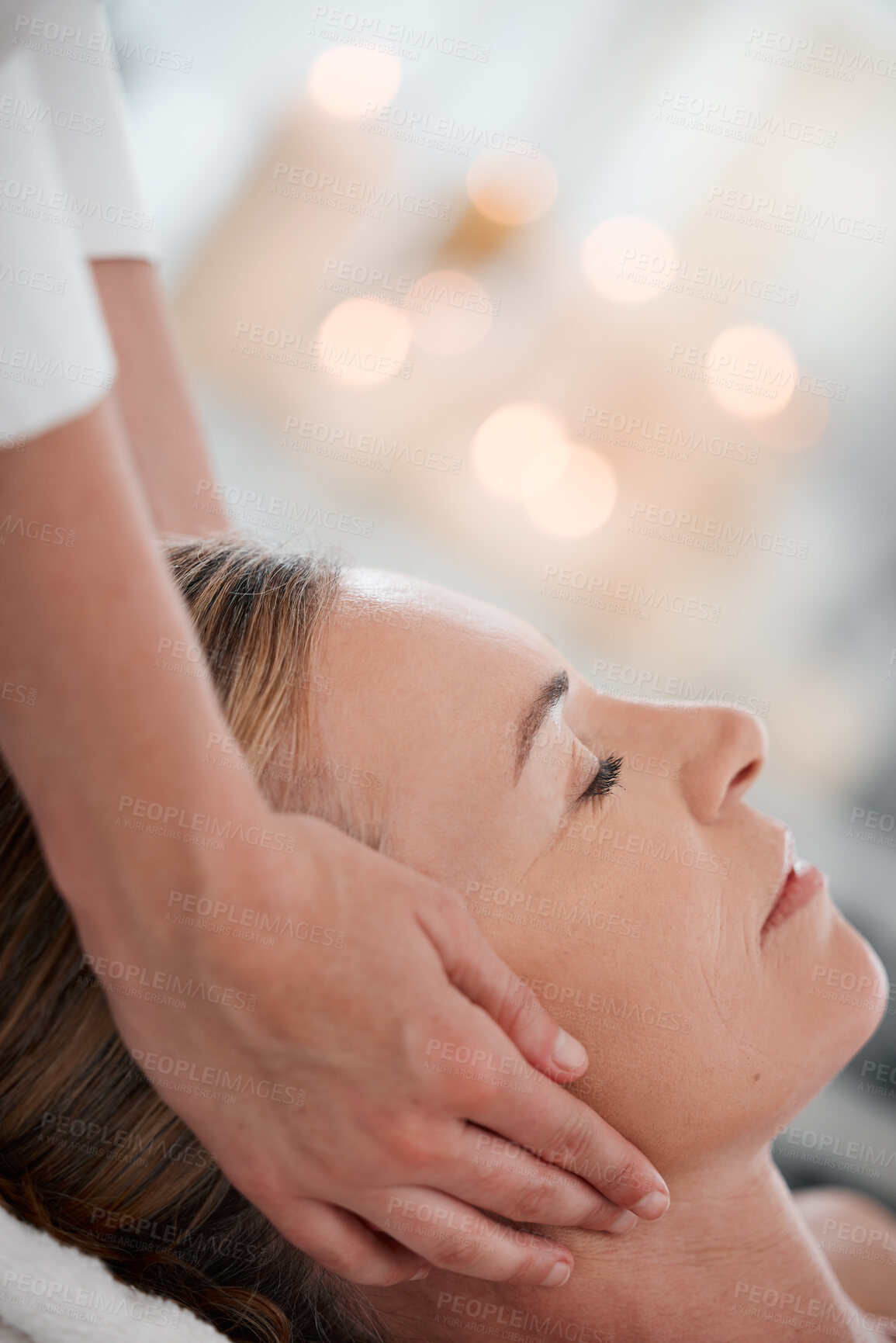 Buy stock photo Shot of a woman receiving a facial massage while at a spa