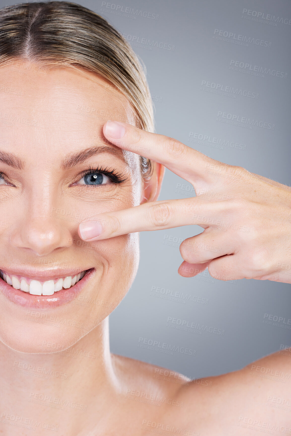 Buy stock photo Peace sign, beauty and portrait of woman in studio for cosmetics, wellness and facial treatment. Dermatology, salon and person with hands for eyes, anti aging and natural skincare on gray background