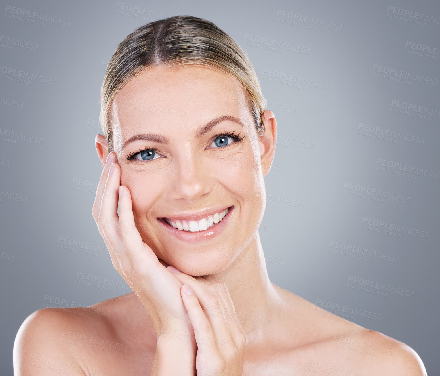 Buy stock photo Woman, touch and beauty in studio for skincare, smile and luxury spa treatment on gray background. Girl, happy and confidence for healthy skin, self care and wellness with facial transformation