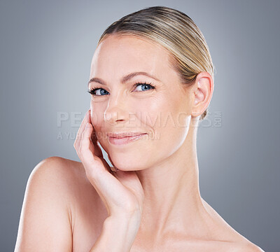 Buy stock photo Woman, facial and touch in studio for skincare, beauty and luxury spa treatment on gray background. Model, happy and confidence for healthy skin, self care or wellness with transformation in portrait