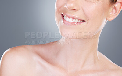 Buy stock photo Studio shot of an unrecognisable woman smiling against a grey background