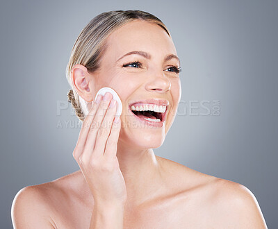 Buy stock photo Happy woman, cotton pad and beauty with makeup for foundation, blush or removal on a gray studio background. Female person or model with smile or patch for applying cosmetics or facial treatment