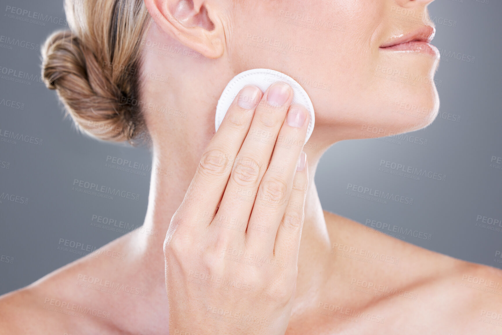 Buy stock photo Woman, hands and cotton pad with cosmetics for skincare, foundation or makeup removal on a gray studio background. Closeup of female person or model with patch for applying beauty or facial treatment