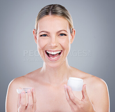 Buy stock photo Studio portrait of an attractive mature woman holding a beauty product against a grey background