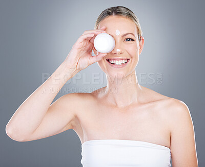 Buy stock photo Happy woman, portrait and skincare cream with container for moisturizer on a gray studio background. Young female person or model with smile for facial treatment, lotion or anti aging cosmetics