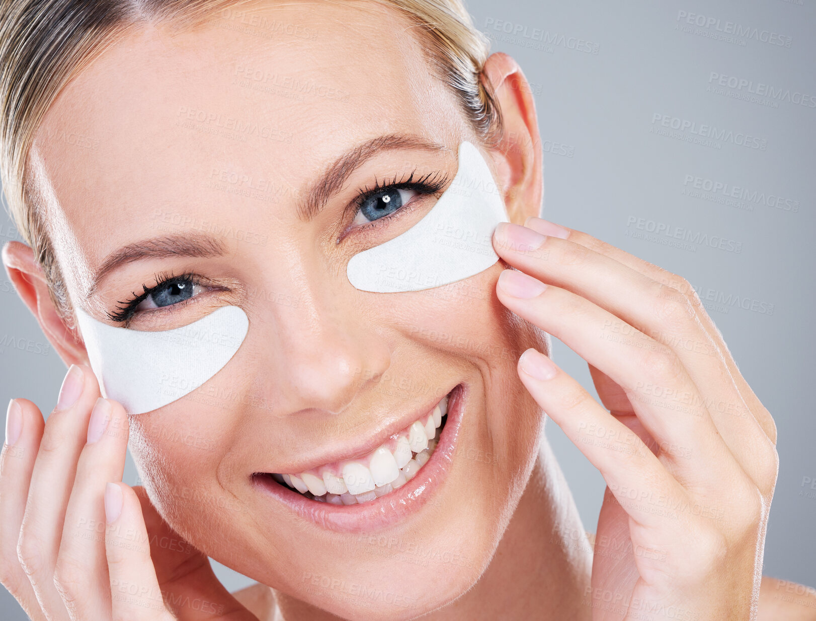 Buy stock photo Studio portrait of an attractive mature woman wearing under eye patches against a grey background