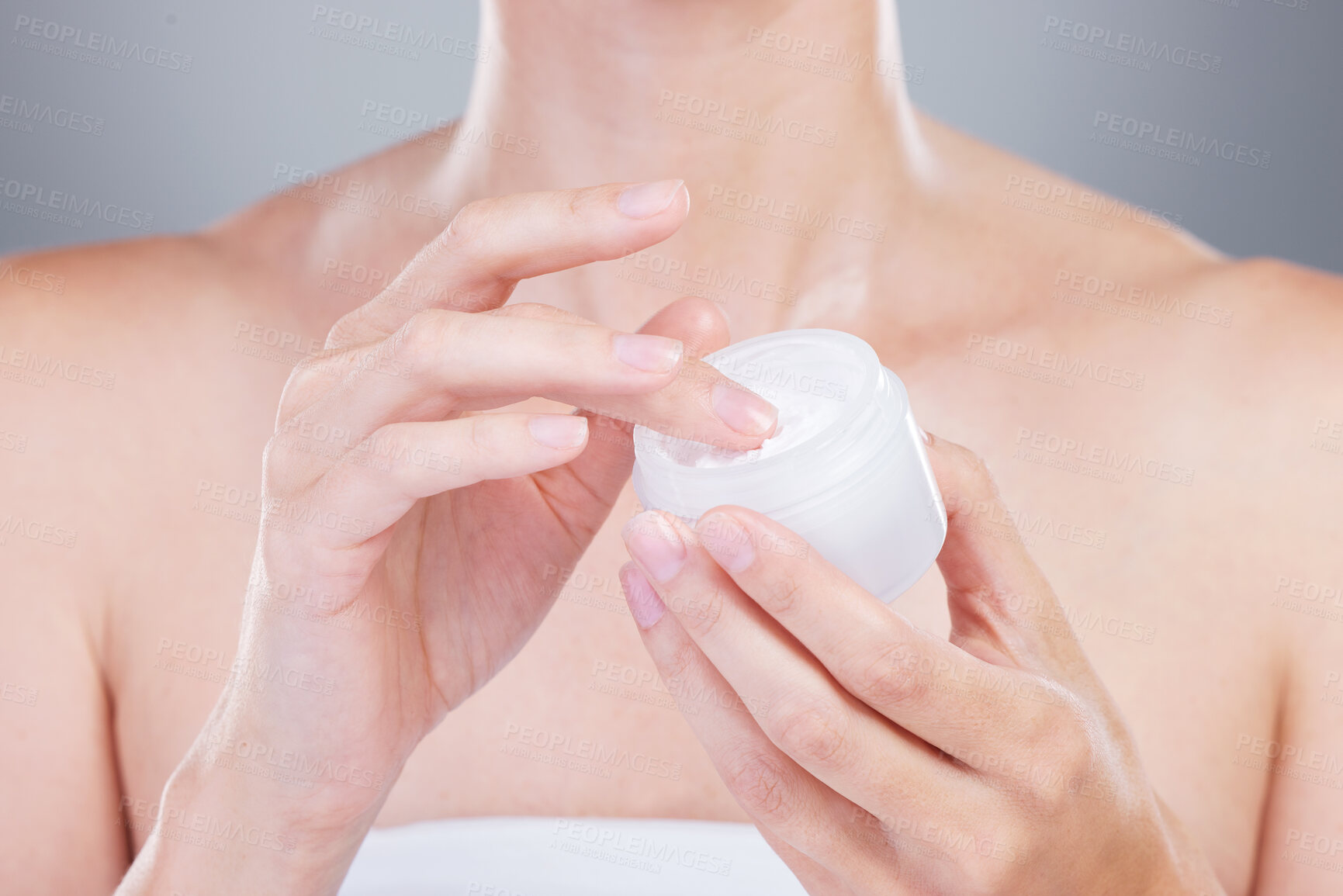 Buy stock photo Woman, hands and cream jar for skincare with hyaluronic acid, natural shine and beauty in studio. Closeup, model and sunscreen container for facial glow, anti aging and dermatology by gray background