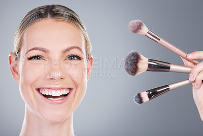 Buy stock photo Makeup brushes, self care and portrait of woman in studio with foundation routine for clear skin. Cosmetic, smile and female person with beauty tools for face cosmetology treatment by gray background