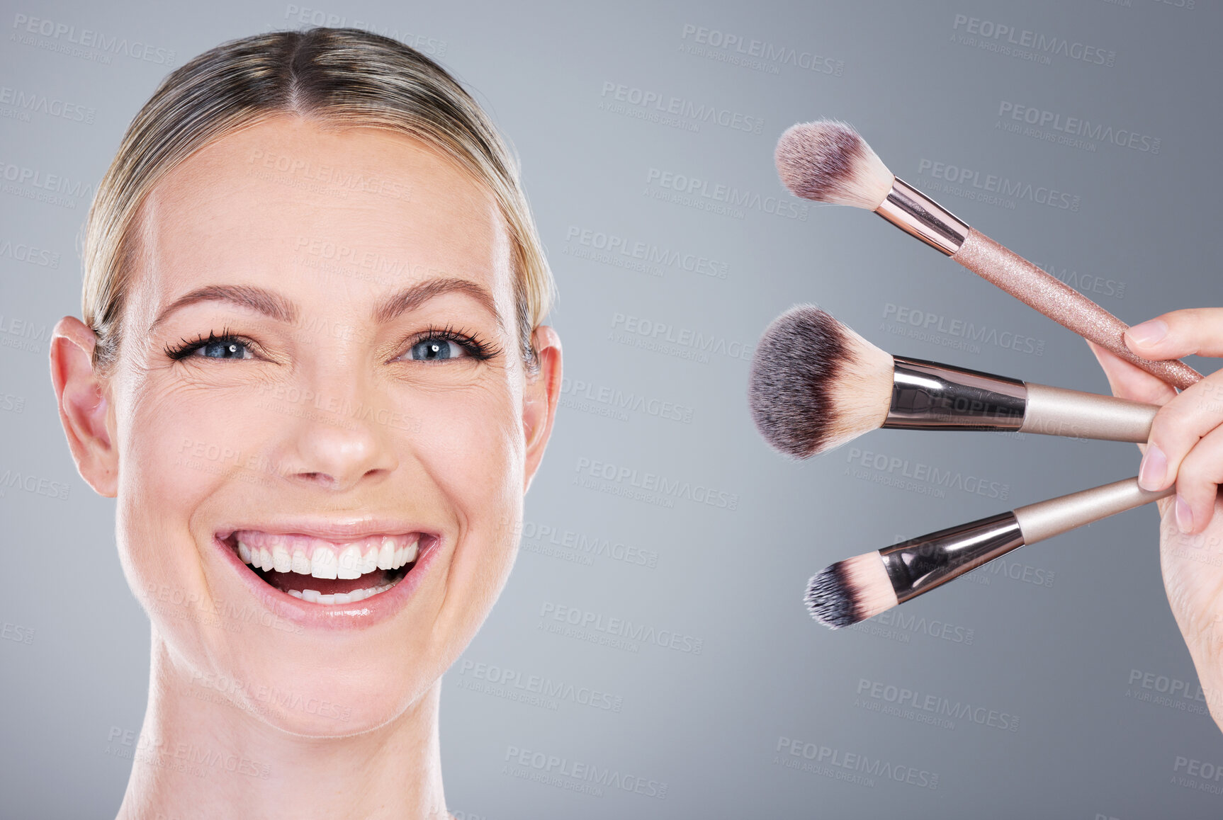 Buy stock photo Makeup brushes, self care and portrait of woman in studio with foundation routine for clear skin. Cosmetic, smile and female person with beauty tools for face cosmetology treatment by gray background