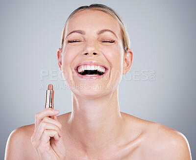 Buy stock photo Studio shot of an attractive mature woman applying lipstick against a grey background