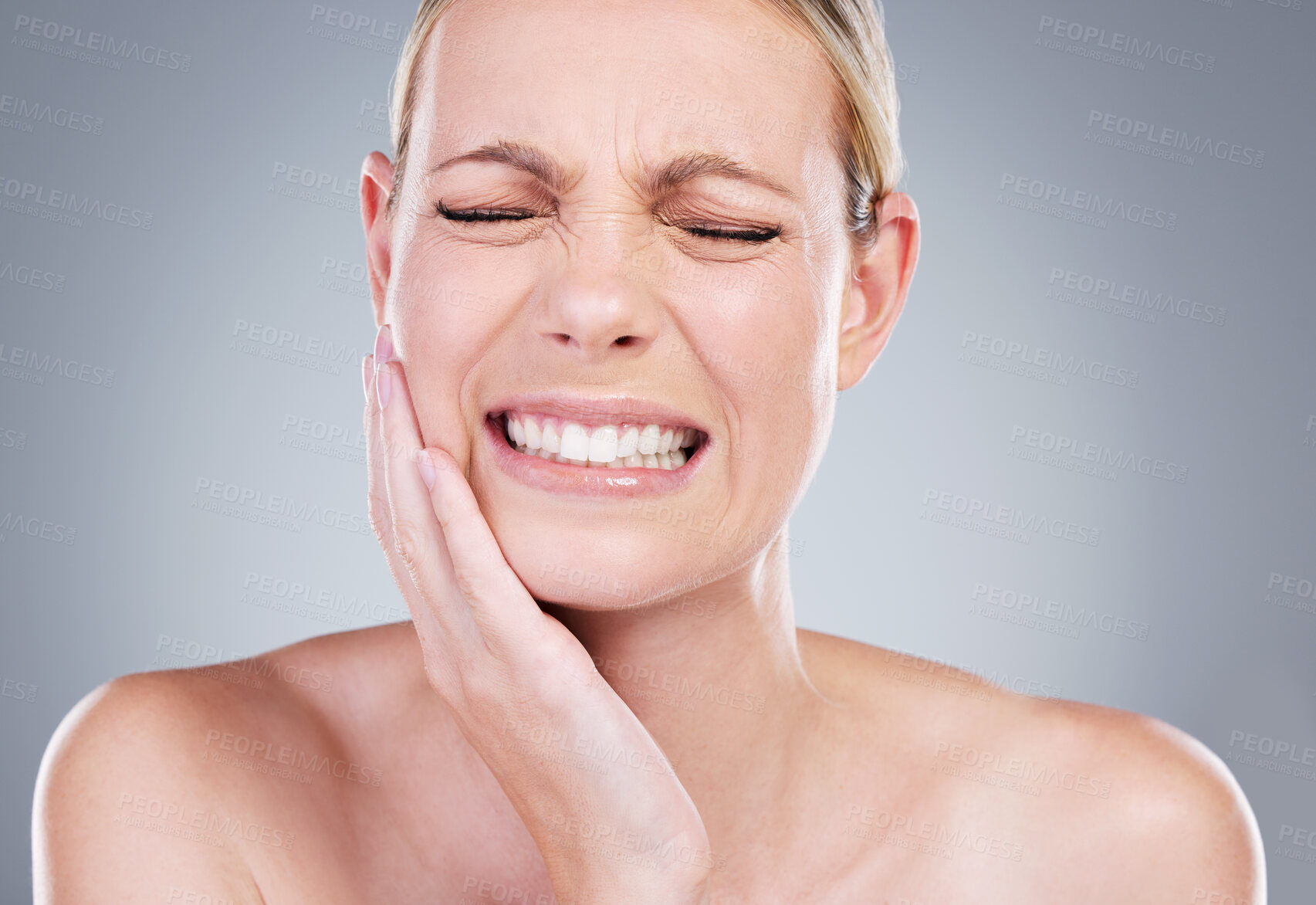 Buy stock photo Injury, dental and woman in studio with toothache, inflammation and infection of gum disease. Female person, pain and hurt of sinusitis, sensitive teeth and growth of decay wisdom by gray background