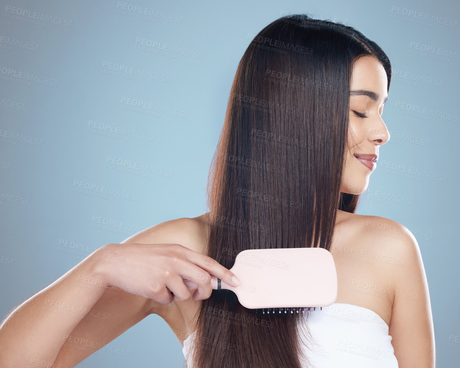 Buy stock photo Woman, brush and hair care in studio with beauty for luxury salon treatment, shampoo or cosmetic. Girl, smile and healthy texture, transformation and growth for hairdresser results on blue background