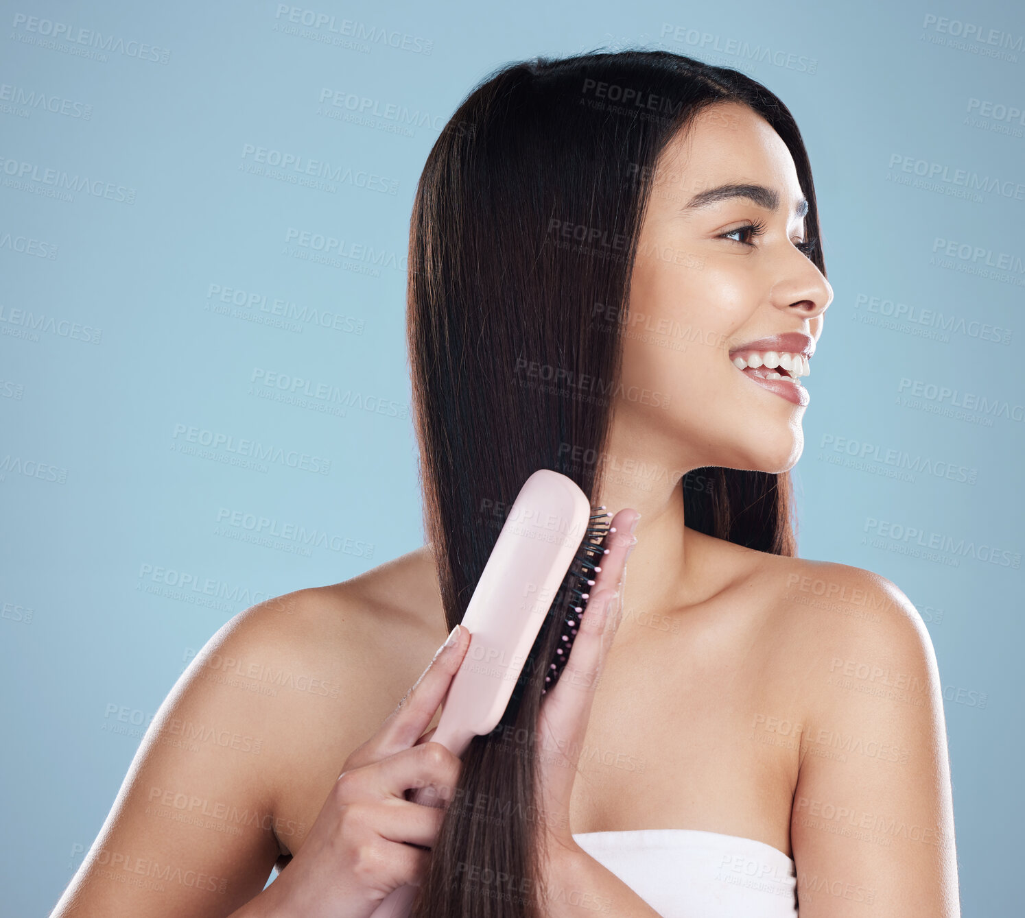 Buy stock photo Woman, happy and hair care in studio with brush for luxury salon treatment, shampoo or cosmetic. Girl, smile and healthy texture, transformation and growth for hairdresser results on blue background