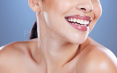 Buy stock photo Cropped shot of an unrecognisable woman posing alone against a blue background in the studio