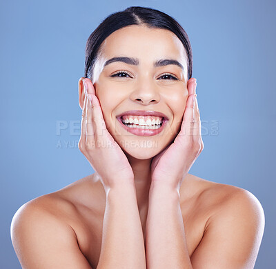 Buy stock photo Shot of an attractive young woman posing alone against a blue background in the studio