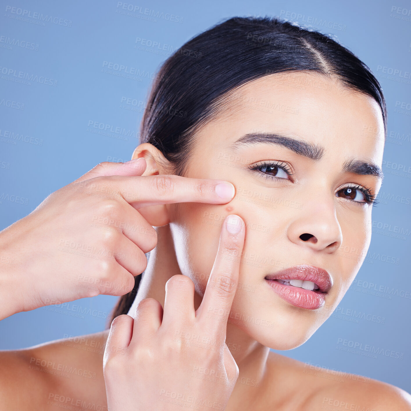 Buy stock photo Woman, worry and portrait squeeze for acne with skincare problem, scar and blackhead removal in studio. Female person, stress and pop pimple for beauty fail, crisis and isolated by blue background