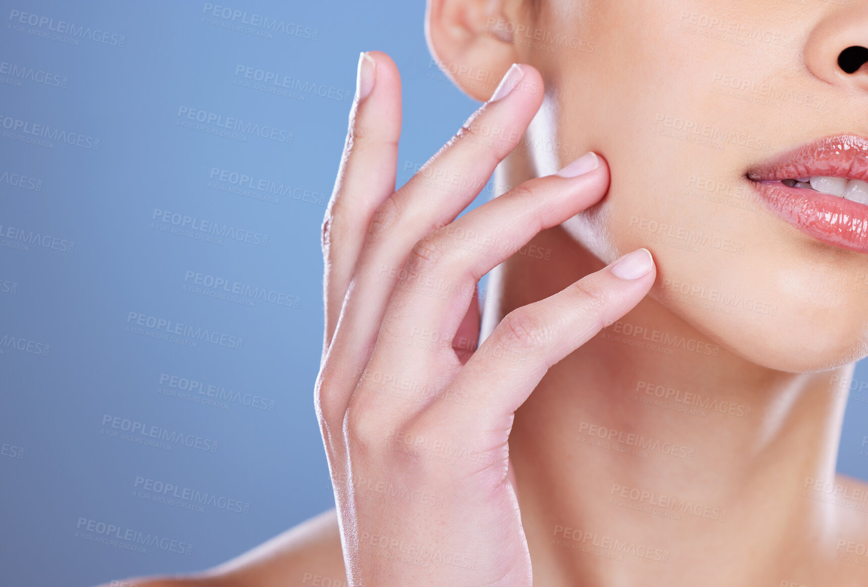 Buy stock photo Face, girl and hand for cosmetic, beauty or results with closeup in blue background. Person, dermatology and zoom for wellness, aesthetic and collagen in studio backdrop for skincare or clean nails