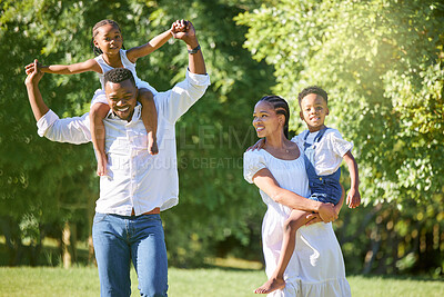 Buy stock photo Shot of a couple spending time outdoors with their two children