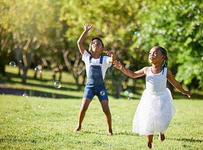 Buy stock photo Shot of an adorable little girl and boy playing together outside