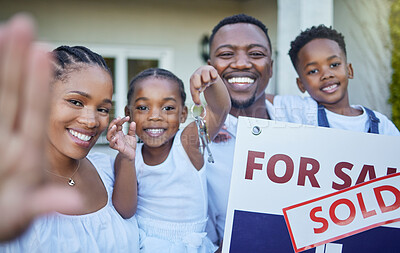 Buy stock photo Shot of a young family posing in front of a house with a sold sign