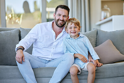 Buy stock photo Cropped portrait of a handsome mature man and his son sitting on the sofa at home