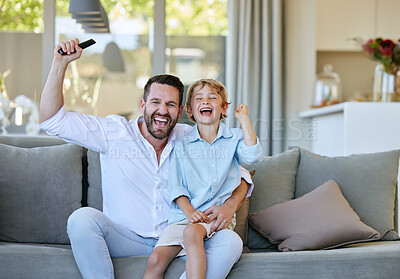 Buy stock photo Cropped portrait of a handsome mature man and his son cheering while watching TV in the living room at home