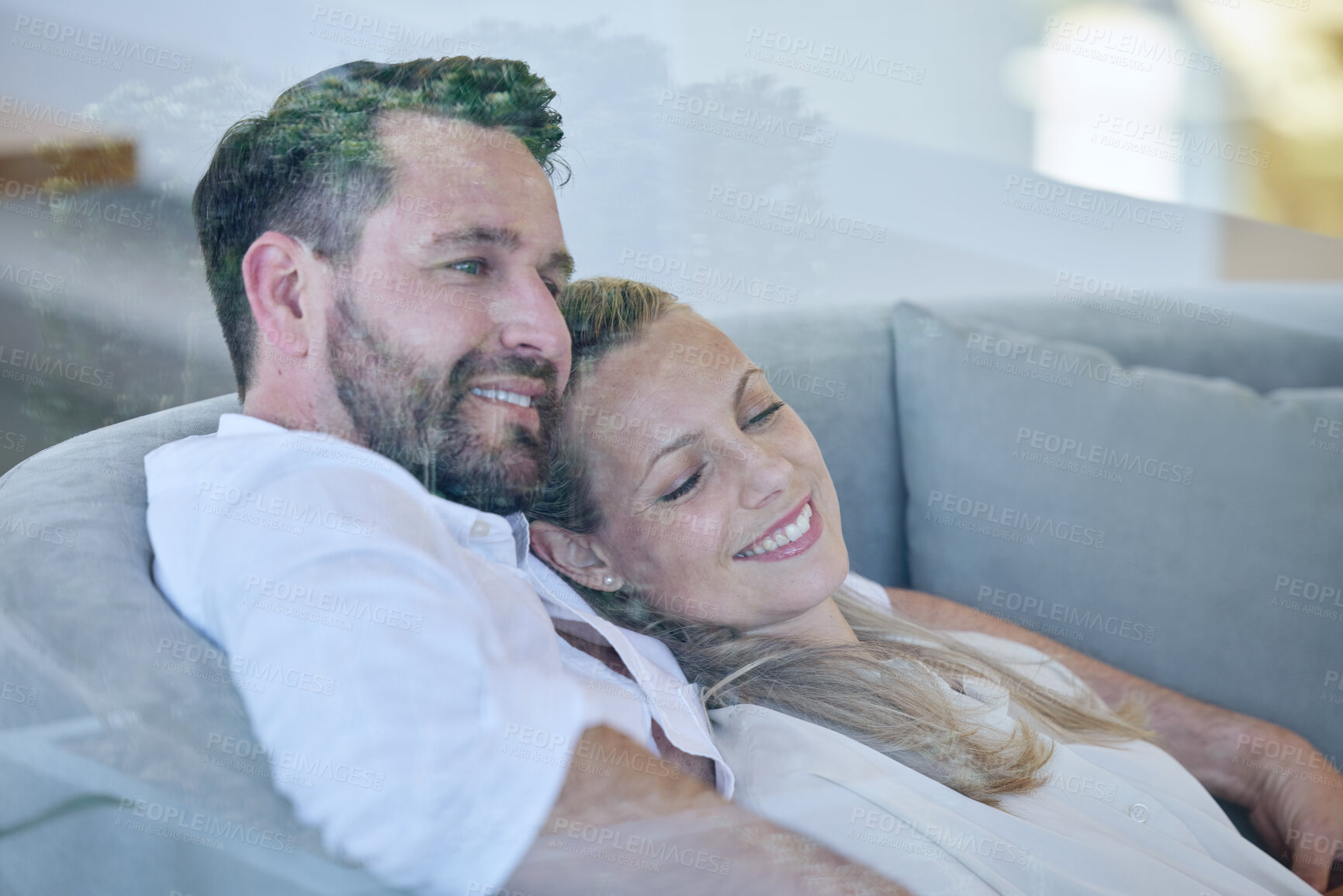 Buy stock photo Cropped shot of an affectionate mature couple relaxing in the living room at home