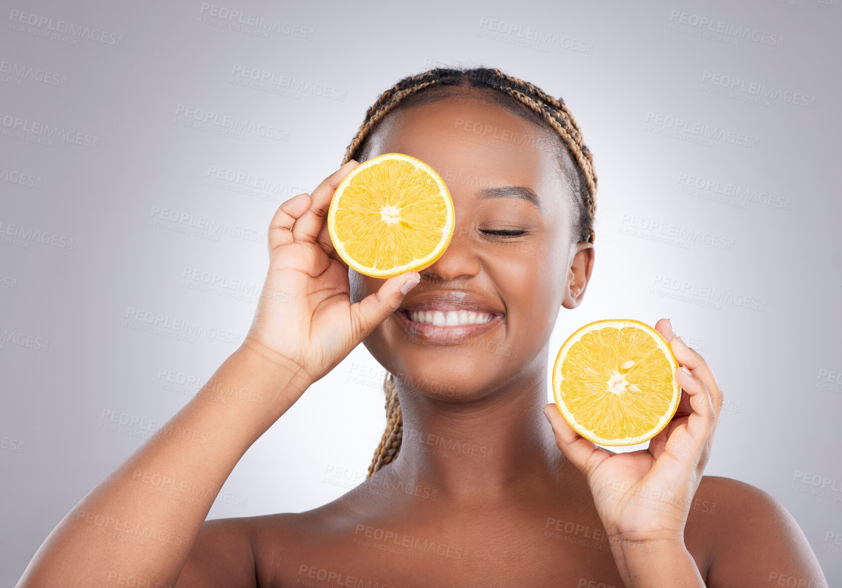 Buy stock photo Beauty, orange and cover with black woman in studio for natural, cosmetics or vitamin c. Nutrition, skincare and detox with face of female model on grey background for citrus fruit and health product