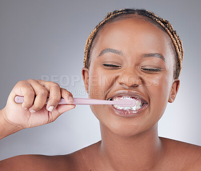 Buy stock photo African woman, brushing teeth and studio with smile, foam and oral wellness by white background. Girl, model and person with plastic toothbrush with toothpaste, health and cleaning mouth for routine