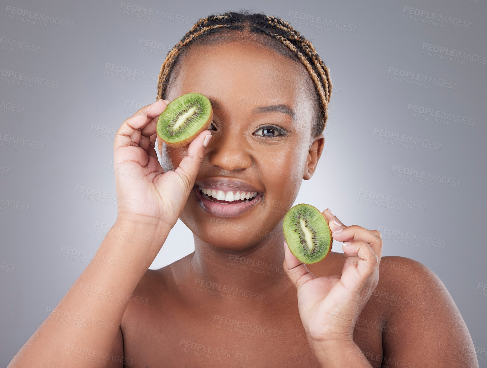 Buy stock photo Black woman, kiwi and portrait with smile in studio with diet, nutrition and detox for gut health by white background. Model, girl person with fruit to cover eye, benefits and vegan to lose weight