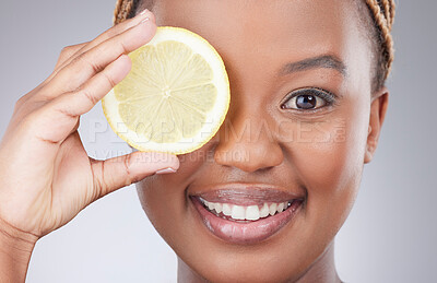 Buy stock photo Portrait, lemon and skincare with black woman in studio for natural, cosmetics or vitamin c. Nutrition, diet and detox with face of female model on grey background for citrus fruit and health product