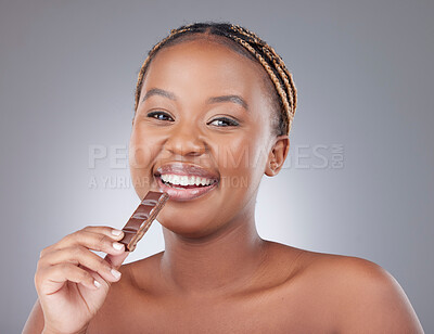 Buy stock photo Black woman, chocolate and portrait with smile in studio with unhealthy diet with calories by white background. African model, person and girl with cacao for eating, candy and happy for sweets