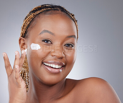 Buy stock photo Portrait, studio and black woman with cream on face for natural beauty, healthy skin and luxury cosmetics. Dermatology, skincare and girl with lotion, facial care and happy routine on grey background