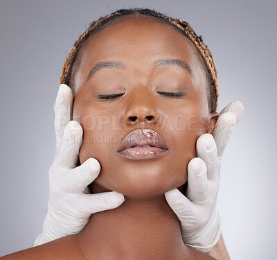 Buy stock photo Plastic surgery, woman and face with gloves in studio for skincare consultation and routine check for procedure. Black person, expert and facial inspection for cosmetics implant on gray background