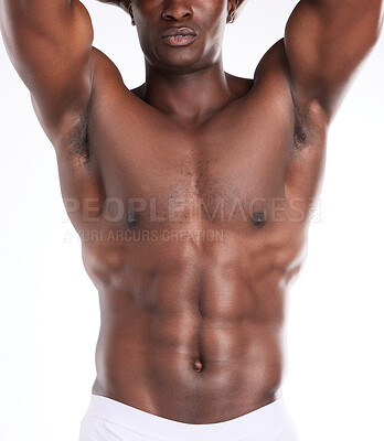 Buy stock photo Cropped shot of an unrecognizable man showing off his muscular body while posing against a white background