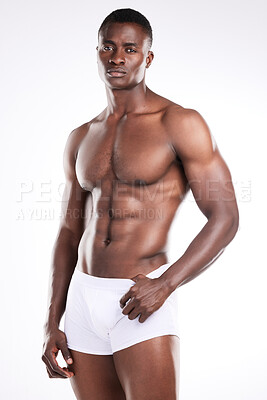 Buy stock photo Portrait of a handsome young man posing shirtless against a white background