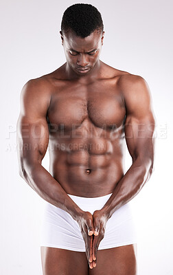 Buy stock photo Shot of a handsome young man posing shirtless against a white background