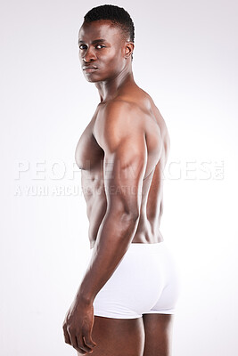 Buy stock photo Portrait of a handsome young man posing shirtless against a white background