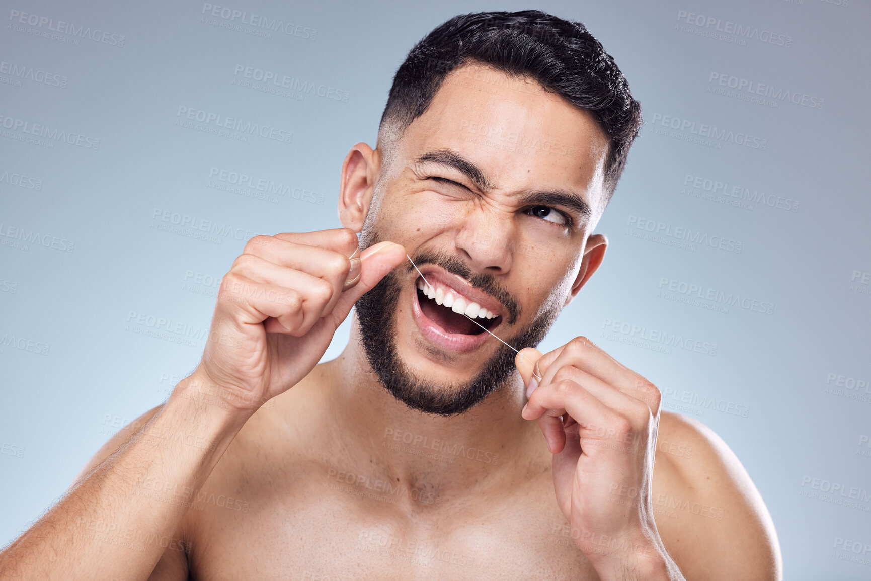 Buy stock photo Man, face and flossing teeth in studio for oral hygiene, mouth cleaning and morning routine for tooth care. Dental, person and thread for fresh breath, plaque and healthy gums on gray background