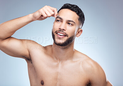 Buy stock photo Beauty, man and tweezers for eyebrow in studio with skincare and happy for facial transformation results. Model guy, hygiene and cosmetics tool for microblading and hair removal by gray background