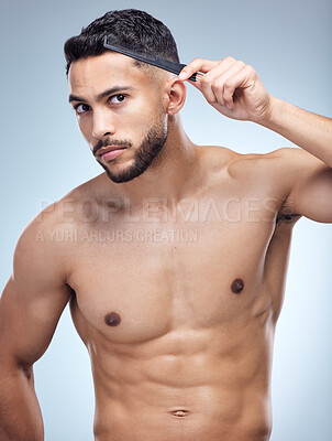 Buy stock photo Comb, hair care and hand of man in studio for grooming, hairstyle or morning routine on white background. Salon, hygiene and model with brush for confidence, scalp wellness or shampoo treatment