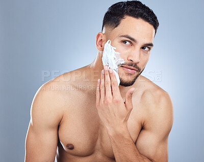 Buy stock photo Man, hands and apply shaving foam for hair removal with skincare hygiene and face transformation in studio. Male person, dermatology and cream or soap product for beard maintenance by gray background