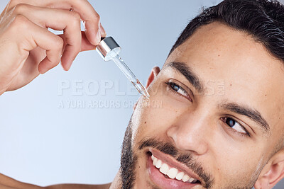 Buy stock photo Skincare, smile and man with facial oil for beauty and results for natural glow or shine in studio. Male person, dermatology and serum with hyaluronic acid for acne scar treatment by gray background