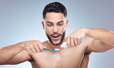 Buy stock photo Man, toothbrush and surprised with toothpaste in studio for oral hygiene, mouth cleaning and morning routine. Dental, person and brushing teeth for fresh breath and healthy gums on gray background