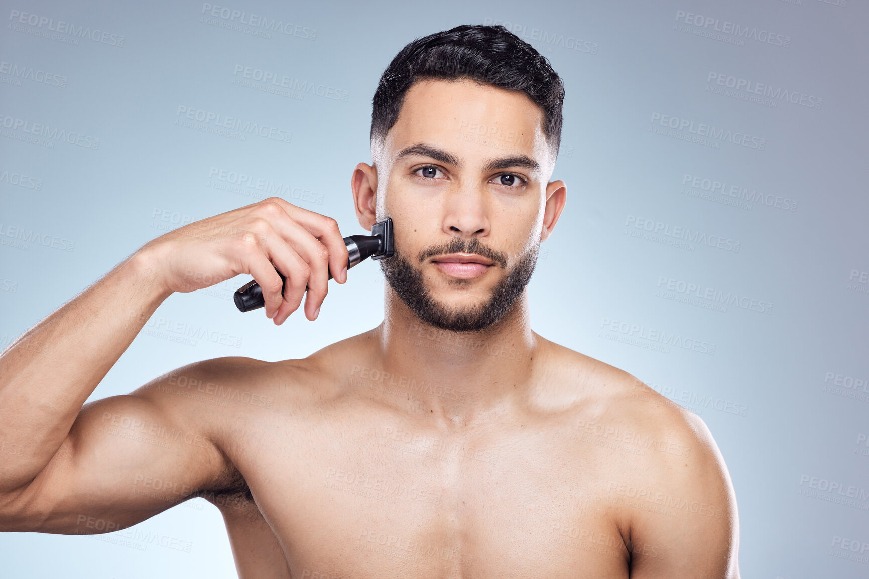 Buy stock photo Man, portrait and hair removal with shaver in studio, facial grooming and wellness or trimmer on background. Cosmetic, cleaning razor and morning routine with model, hygiene and dermatology skincare